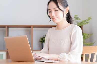 asian woman working on a computer indoors