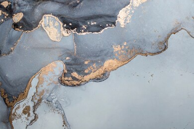 high resolution. luxury abstract fluid art painting in alcohol ink technique, mixture of black, gray and gold paints. imitation of marble stone cut, glowing golden veins. tender and dreamy design.