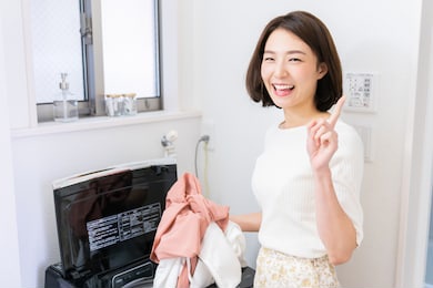 young attractive asian woman doing the laundry