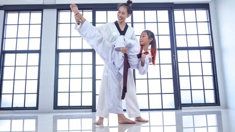 teacher teaching taekwondo girl, korean martial art