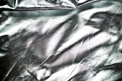 reflecting crumpled wavy material. foil texture.