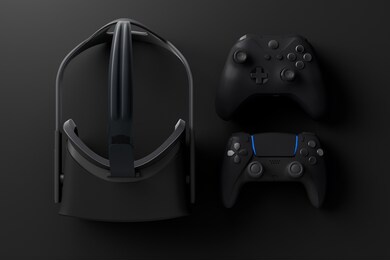 top view of gamer workspace and gear like vr glasses, joystick on black table background. 3d rendering of accessories for live streaming concept