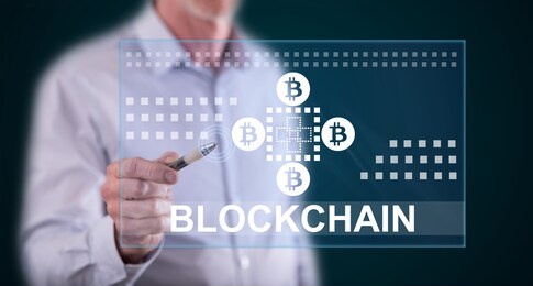 man touching a blockchain concept on a touch screen with a pen