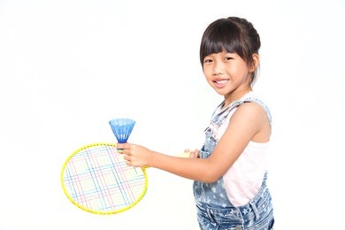 little asian girls with badminton isolate on white background