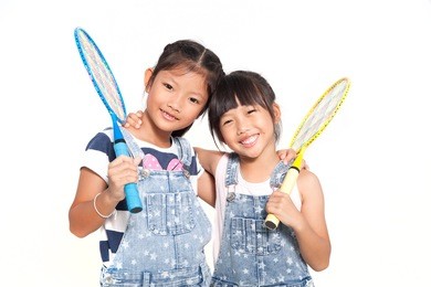 little asian girls with badminton isolate on white background