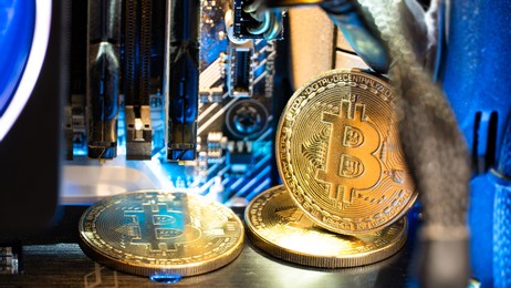 bitcoin golden coins on a motherboard with neon light. 