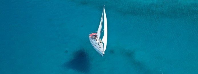 aerial drone ultra wide photo of beautiful sail boat sailing in turquoise ionian island sea