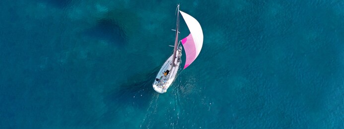 aerial drone ultra wide photo of beautiful sail boat sailing in turquoise ionian island sea