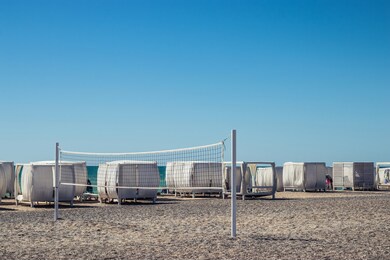 sunny weather on the beach. sea view. sandy beach with a volleyball court. summer resort holidays.