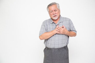 asian senior man with pain on heart isolated on white background, health problem and feeling sick concept