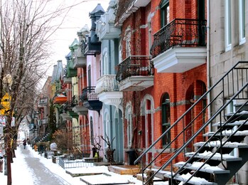 beautiful houses of old historical montreal neighborhood plateau mont royal in winter season, bright painted doors.