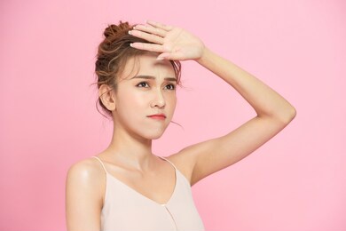 closeup young woman face over pink