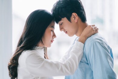 asian couple happily embracing each other
