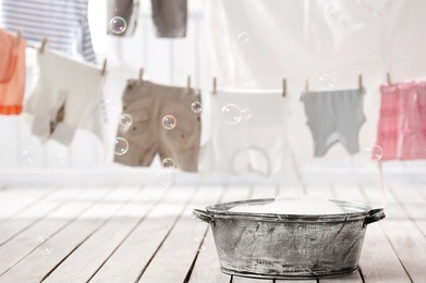 old bowl with soft foam and pear on background hung wash laundry