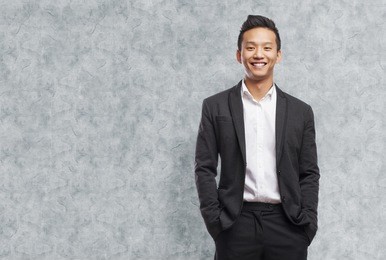 young asian business man smiling standing indoor