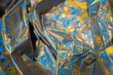 iridescent fabric holographic background. crumpled surface shiny metallic foil