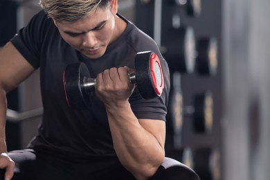 asian young man practice weight training workout in the gym, body building exercise. muscle building challenge concept. strong sportsman lift up a dumbbell close up with copyspace.