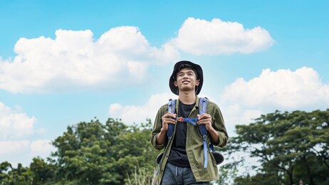 young asian man traveler with backpack in reservoir
