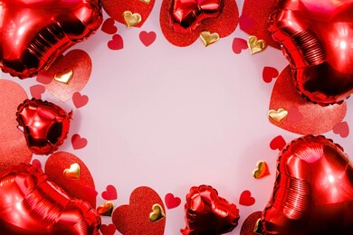 text frame with red and gold hearts foil balloons top view on pink valentine's day background. copyspace.