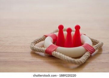 health insurance or life insurance business and health care concept. people model in lifebuoy on wooden table background copy space.