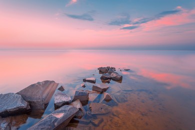 beautiful sunset landscape with sea gangway stones. long exposure shot.