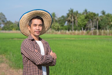 asian farmer man standing cross arms with blue sky background