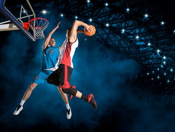 two basketball players in action in arena. blocked shot