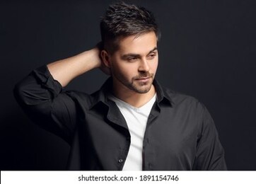 handsome man with stylish hairdo on dark background