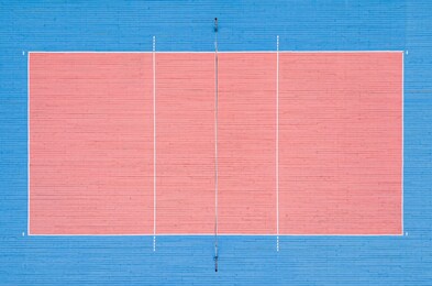 volleyball court top view. pink and blue wooden floor in the gym.