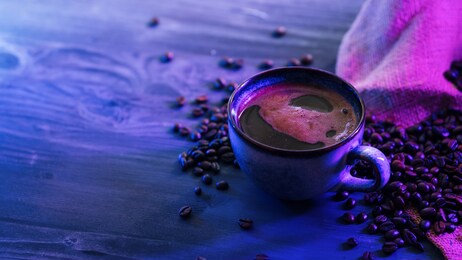 ceramic cup with espresso coffee . trendy neon shades of light. copy space