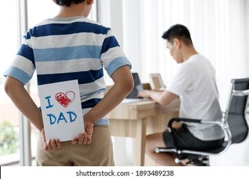 i love you, dad. asian happy family son surprise, made a greeting card for daddy on father's day. conecept