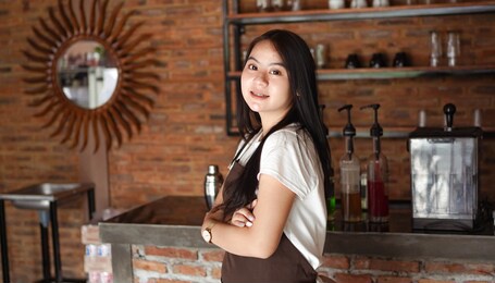 asian woman barista smilling look camera at cafe