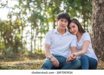 portrait of young asian couple in love  in the forest,thailand people happy to be together,valentine day concept
