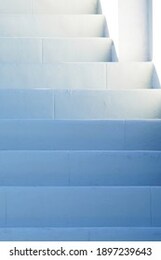 white painted stairs shaded in the blue afternoon light outside in the fresh air, getting lighter towards the top             