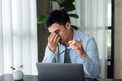 sad depression serious people from work,study stress concept.asian man feeling tired suffering using computer working work place.concept global economic,health problems