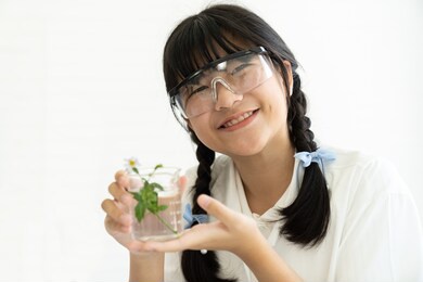 asian girl scientists learning science and doing analysis and holding glassware in the laboratory. early development of children. scientific experiment and research concept