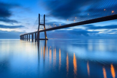 background with nighy lights on the lisbon bridge. the vasco da gama bridge is a landmark, and one of the longest bridges in the world. urban landscape. portugal is an amazing tourist destinatio