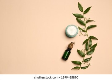 flat lay composition of organic cosmetics made with snail mucin on beige background. space for text