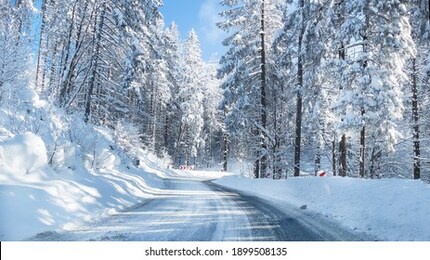 snowy winter road in a mountain forest. beautiful winter landscape.