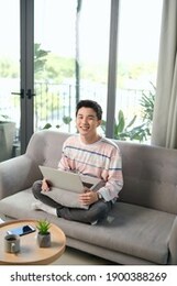 happy young man uses his laptop to check email and check work online. working at home concept.