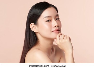 beautiful young asian woman with clean fresh skin on beige background, face care, facial treatment, cosmetology, beauty and spa, asian women portrait
