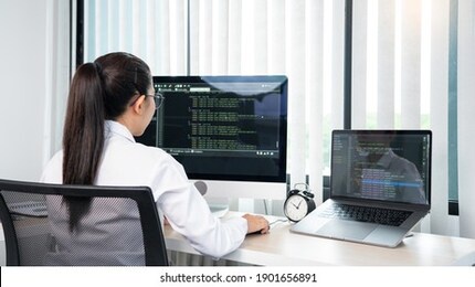 asian woman programmer typing source codes programming on computer in office, freelance web developer concept 
