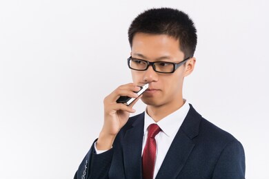 young man shaving his beard off with an electric shaver