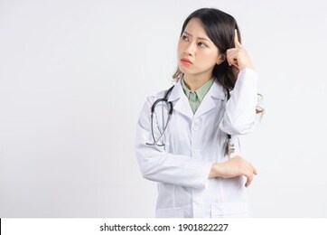 portrait of an asian female doctor scratching her head in thought
