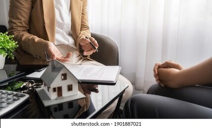 real estate agent and customer discussing for contract to buy, get insurance or loan real estate or property.