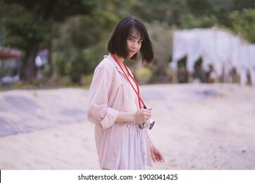 asian travelling woman be smile with classic 35mm rangefinder film camera, woman relaxing in holiday summer