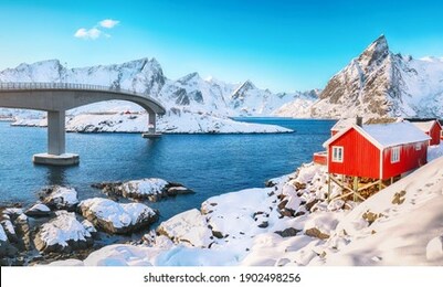 charming winter view on hamnoy village and bridge to olenilsoya island. popular tourist destination on lofotens.   location: hamnoy,  moskenesoya , lofoten; norway, europe