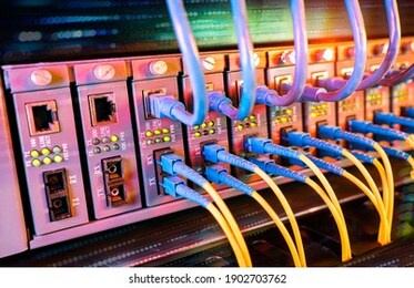 fiber optical cables connected to an optic ports and network cables connected to ethernet ports