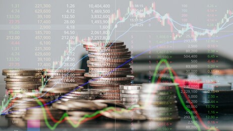 financial stock market graph and rows of coins for finance and business, stock market chart growth, abstract and symbol, business investment, and currency exchange, on blue background.
