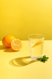 fresh still water on a yellow background with lemon and mint